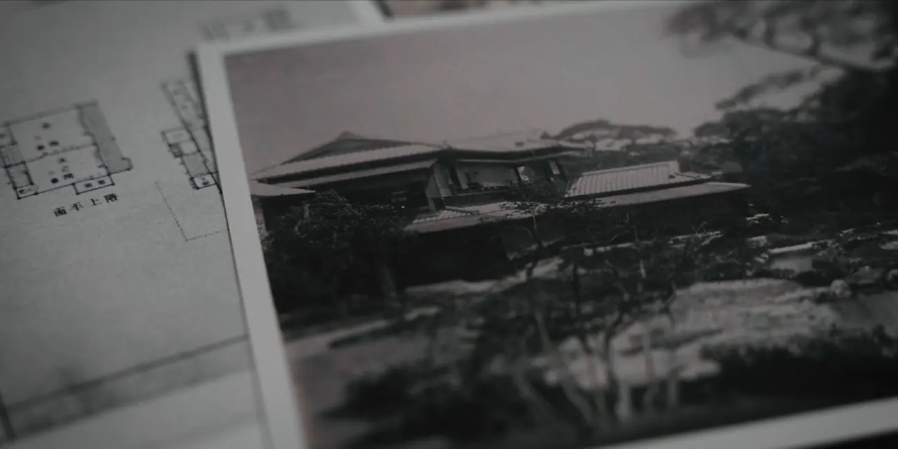 An archive photograph of a villa beside its floor plan, printed and filmed as a physical object.